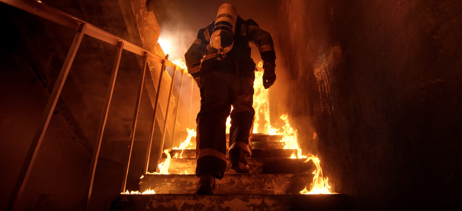 Fire Fighter Climbing Stairs In Protective Wear